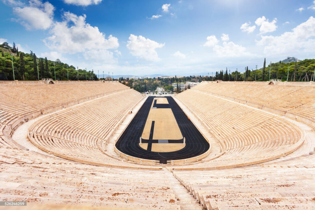 Symmetric view of Panathenaic Stadium in Athens, Greece in summer with stairs and city on background